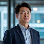 Portrait of Professor Liam Chen, AI Research Director at Veridian Bloom.