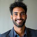 Portrait of David Patel, a calm-looking man in his 40s in business casual attire.