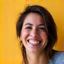 Portrait of Maria Rodriguez, a cheerful woman in her 20s, perhaps a student or young professional.
